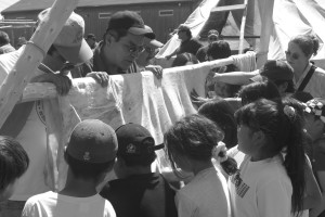 Children learning how the moose hide looks when it's ready for stretching and drying